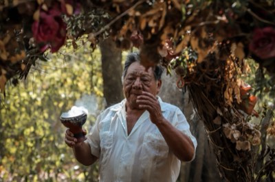 Local shaman leading a traditional Maya purification ceremony