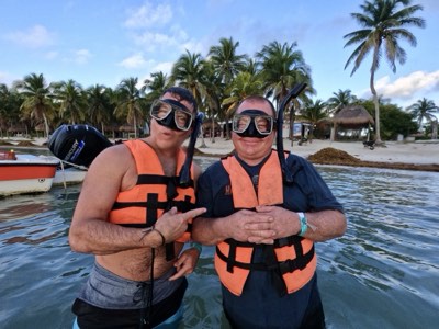 Snorkeller floating face-down over the seagrass beds of Akumal bay