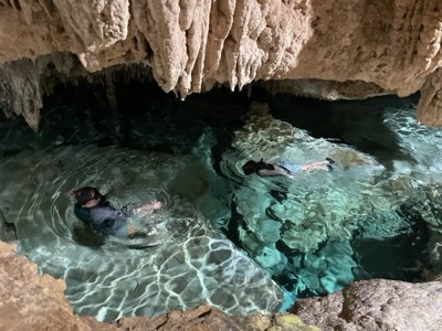 Cave cenote in the Riviera Maya with light falling through the opening