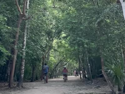 Riding bikes along the jungle path at Coba