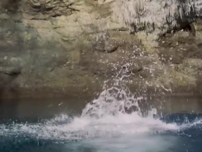Jumping from the rocks into a Coba cenote