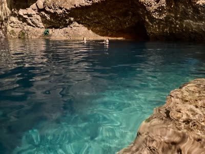 Swimming in the clear water of an underground cenote