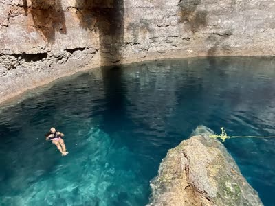Floating in the turquoise water of an underground cenote