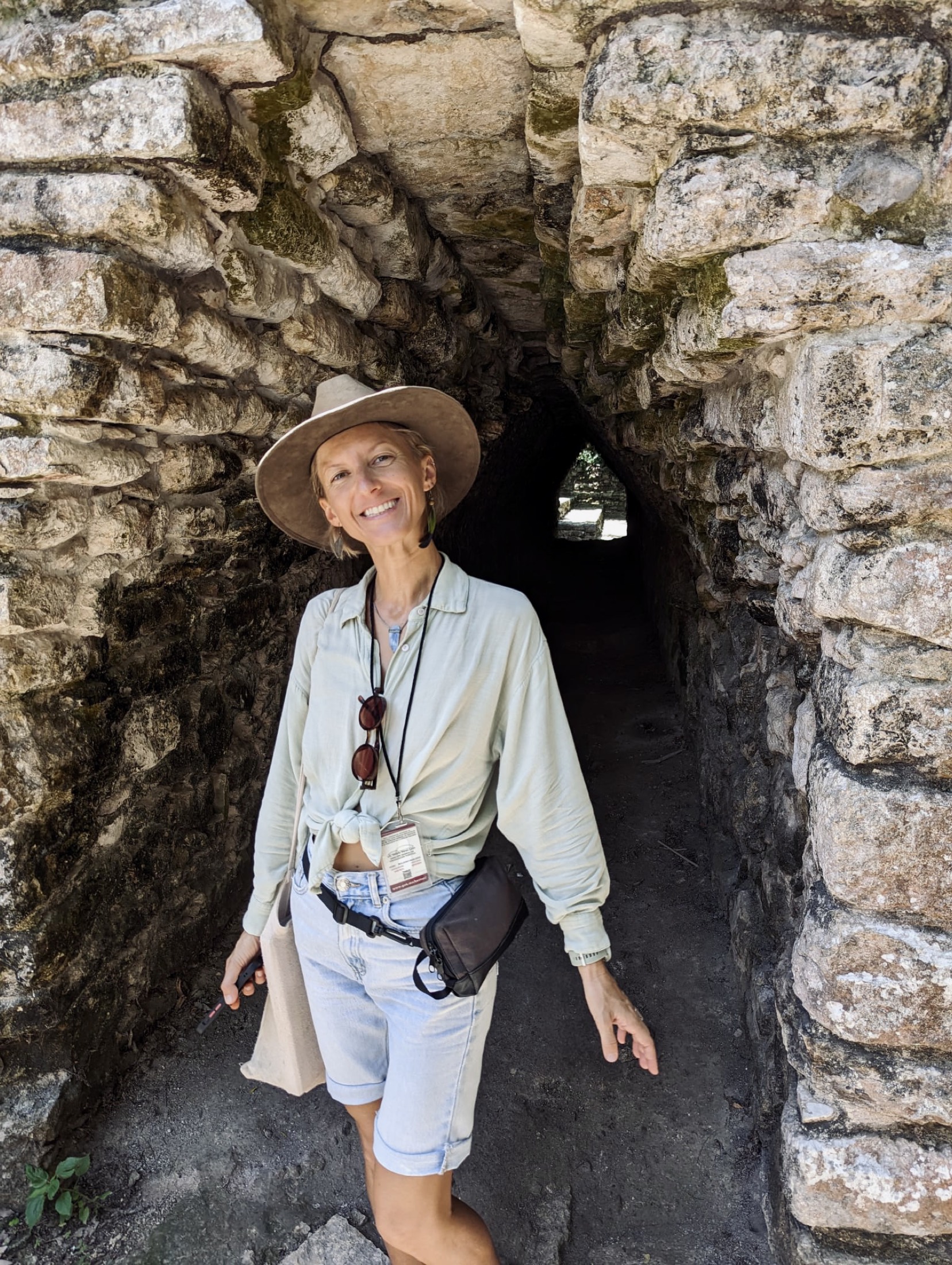 Kat B., private tour guide, in a stone passageway at the Cobá ruins