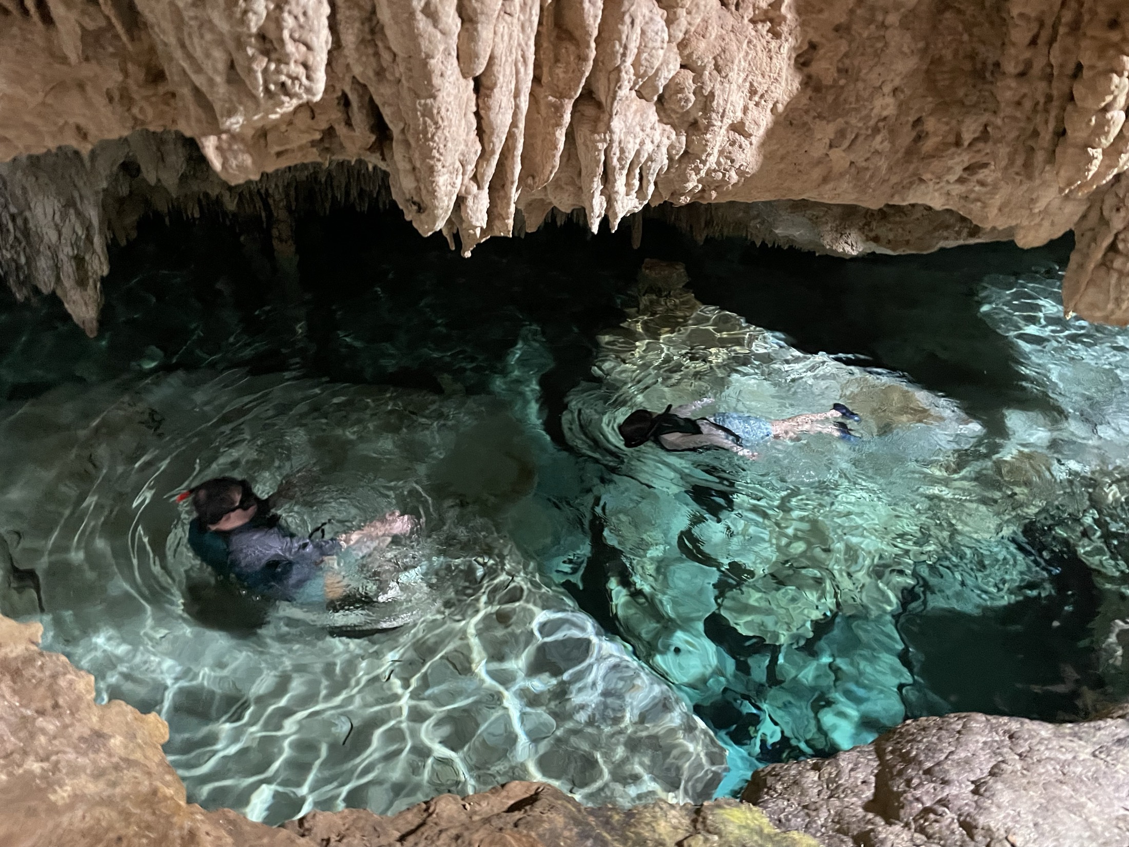 Cave cenote in the Riviera Maya with light falling through the opening